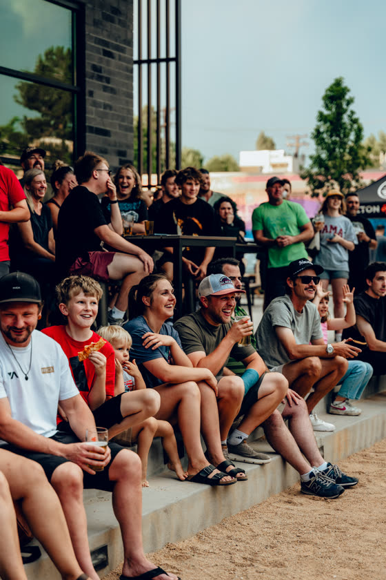 Neighbors packed onto the bleachers at an outdoor community event